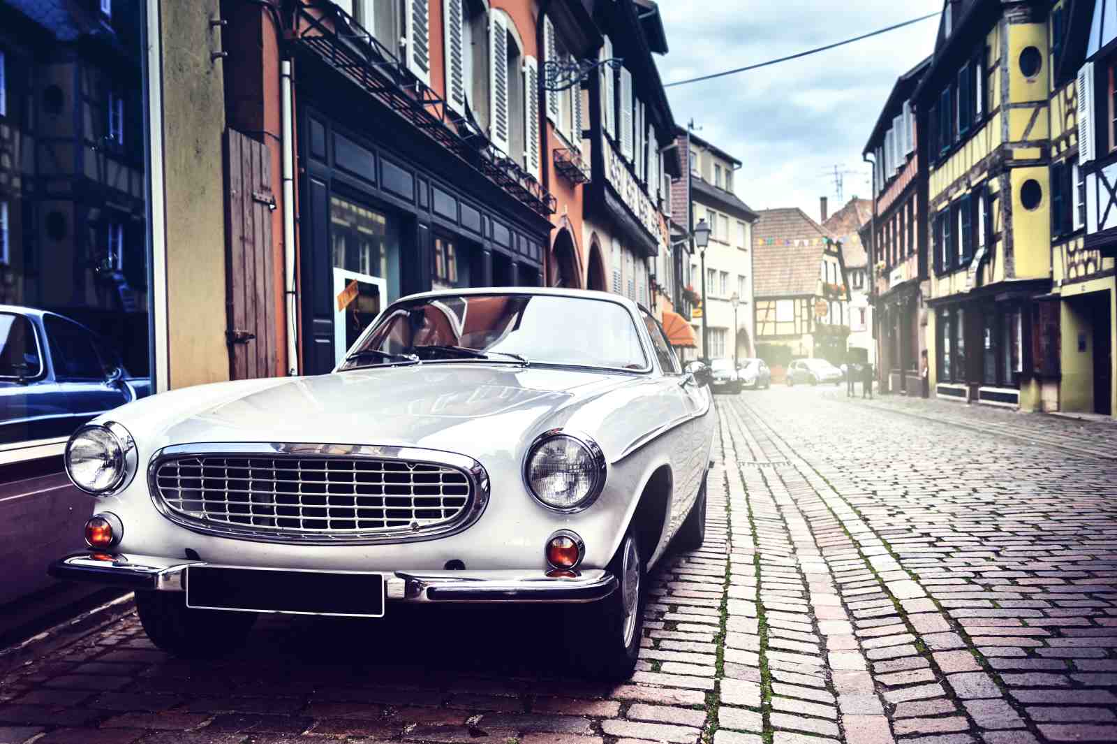 Vintage White Classic Car on Cobblestone Street Wall Art