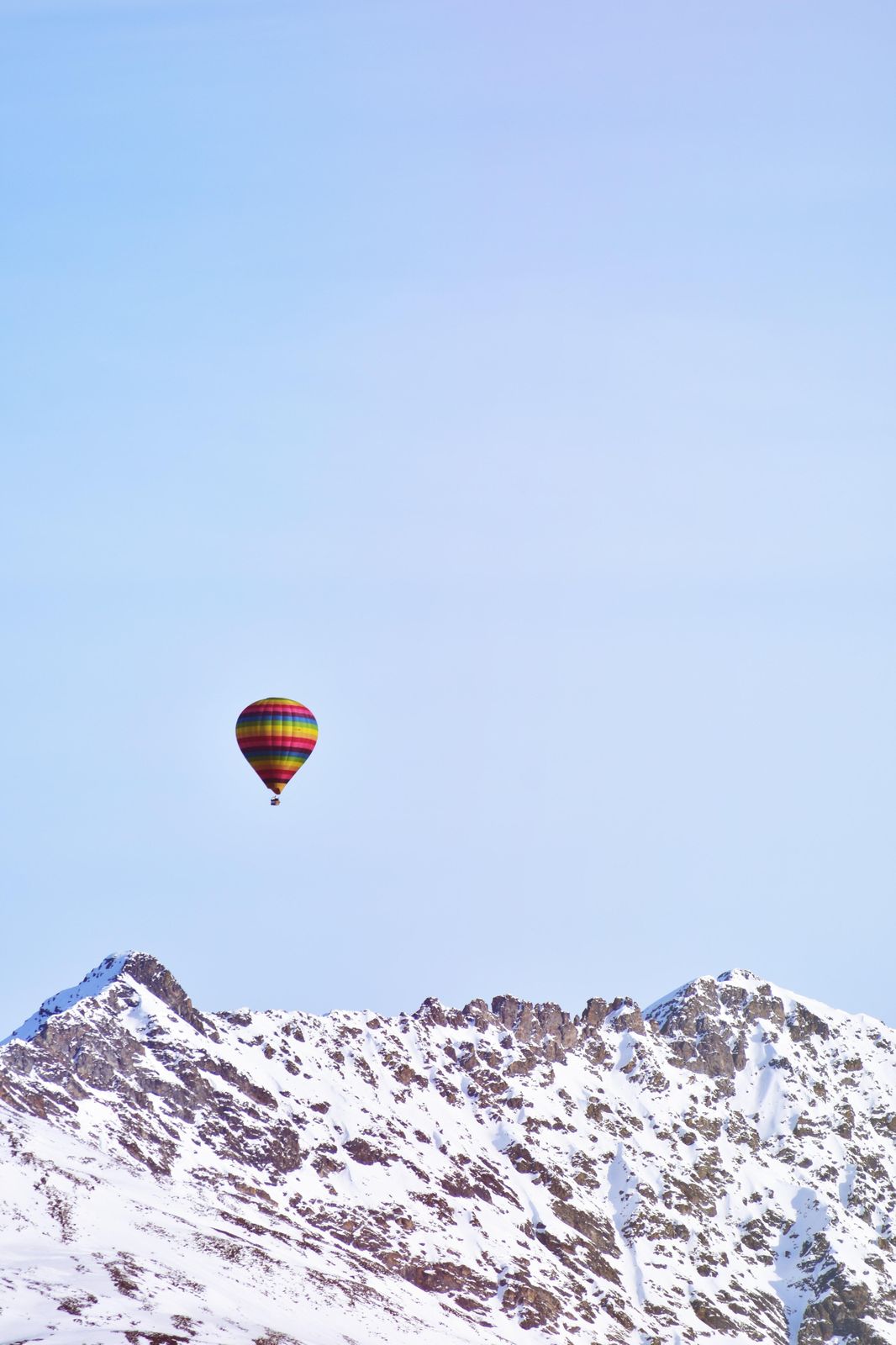 Vibrant Hot Air Balloon Over Snowy Peaks Wall Art