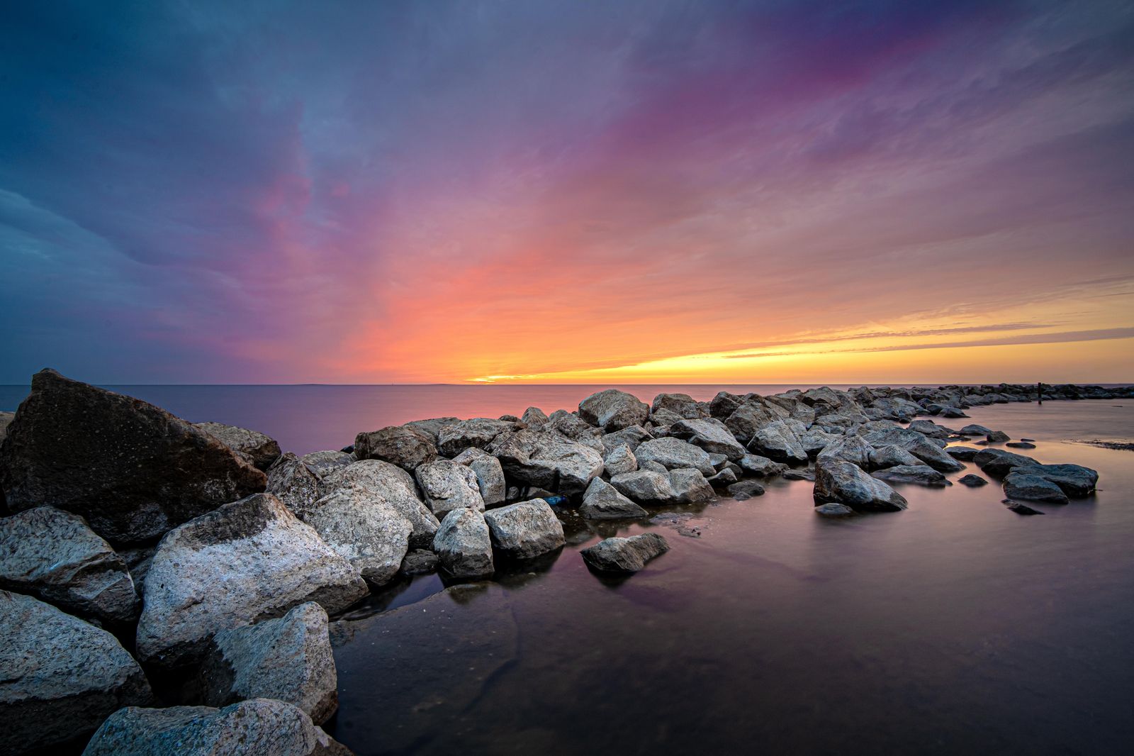 Serene Sunset Beach Rocks Wall Art