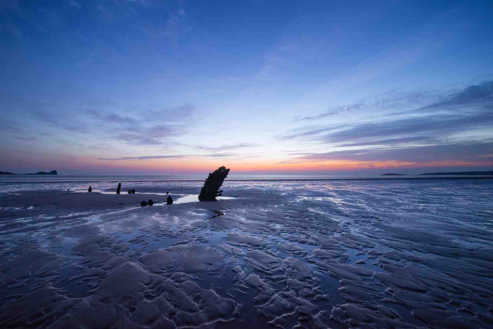 Serene Shipwreck Sunset Beach Wall Art