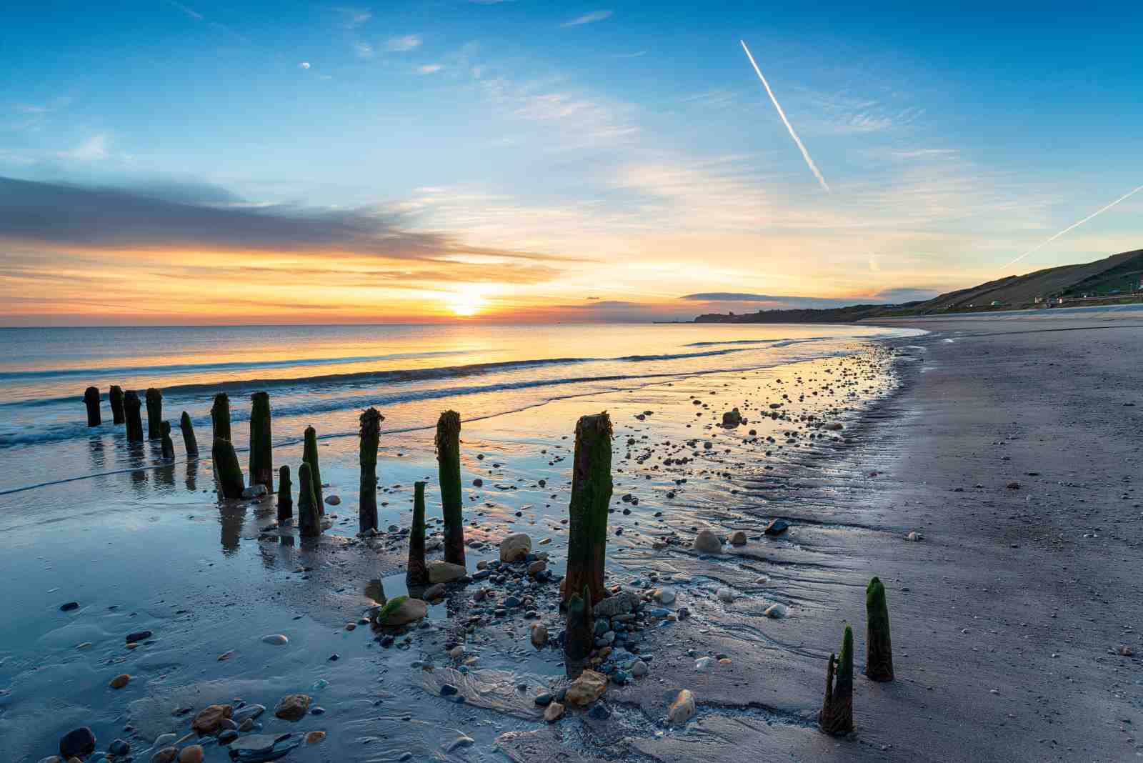 Tranquil Beach Sunset Wooden Posts Wall Art